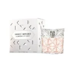 Issey Miyake Lumière d'Issey perfume box beside a geometric-cut crystal bottle with pale pink juice.