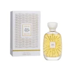 Perfume bottle with sunburst gold design and white cap next to a white patterned box labeled Atelier Nuda Veritas Des Ors.