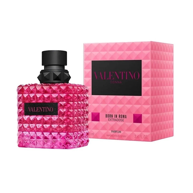 Pink Valentino perfume bottle with a black cap and diamond-patterned textured glass, next to a matching pink box labeled Valentino Donna Born in Roma Extratose/Parfum.